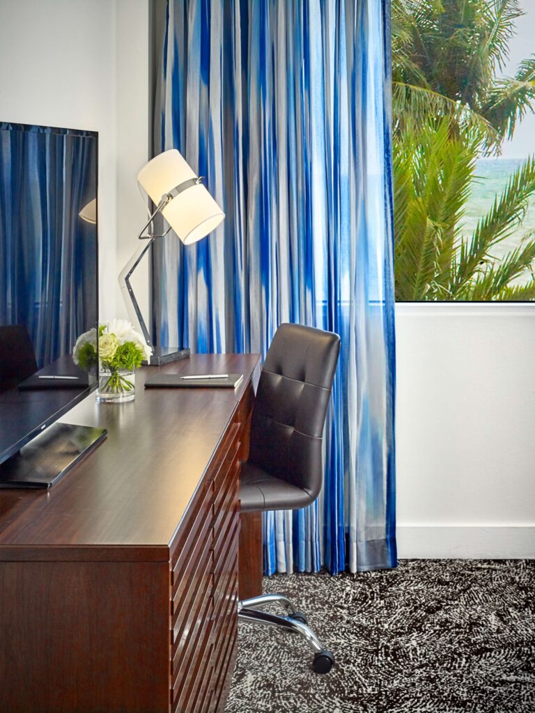 Hotel guestroom work area with a TV.