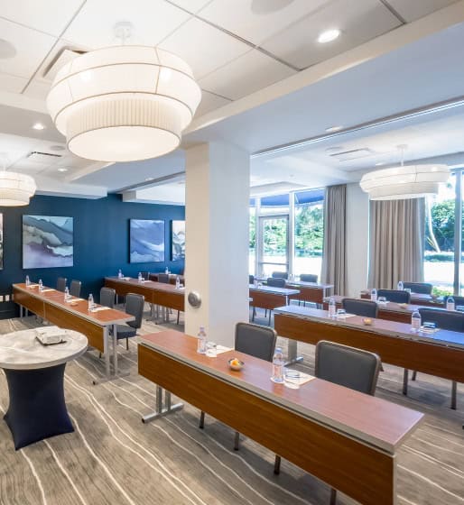 Modern meeting room with tables, chairs, and decor.