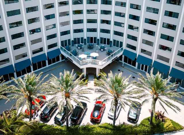 Fort Lauder Hotel exterior with cars park outside.