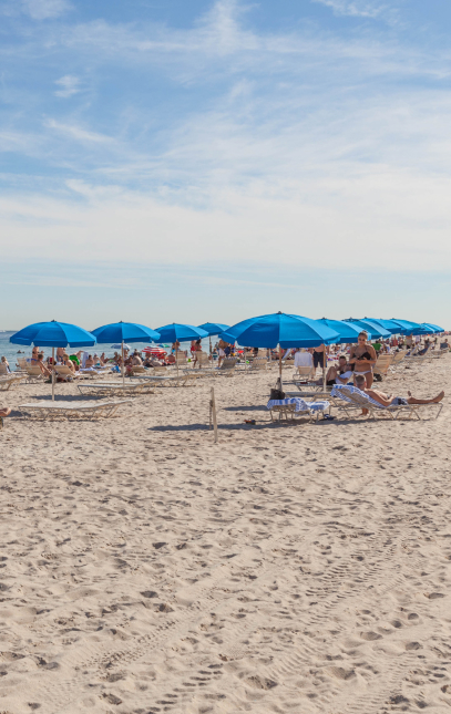 Fort Lauderdale sand beach with blue parasol.