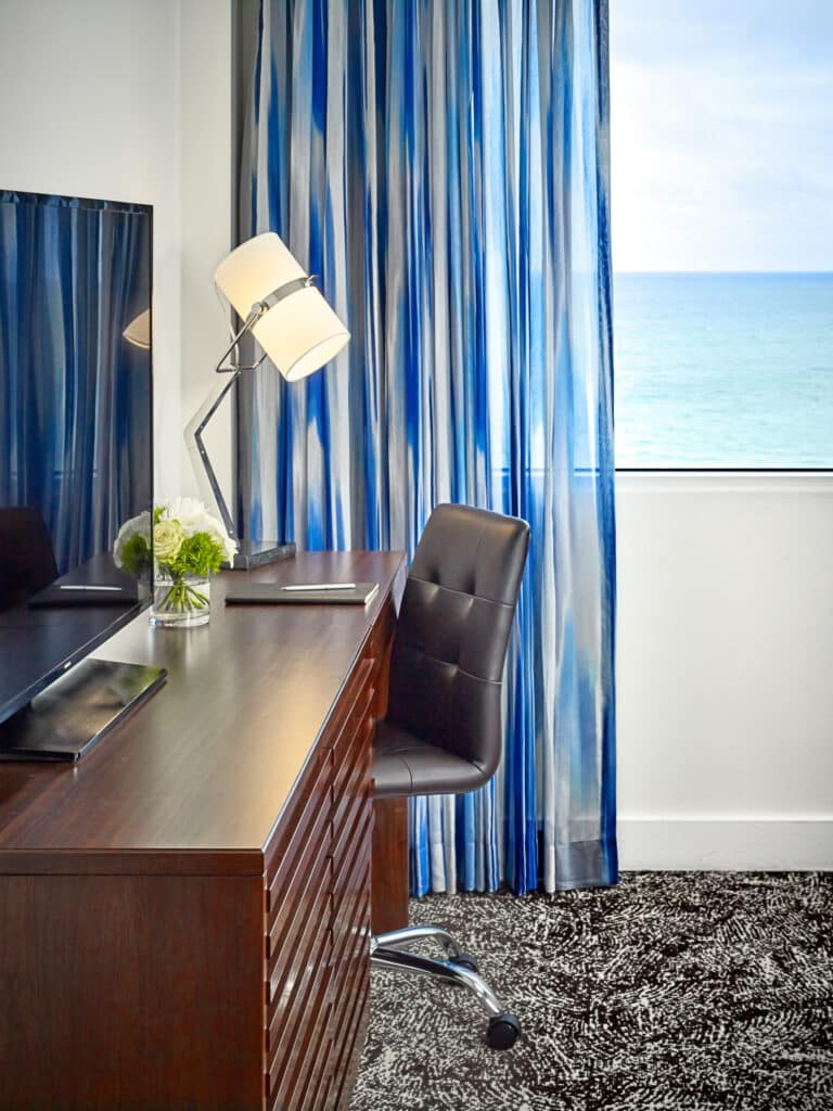 Hotel guestroom work area with a TV.