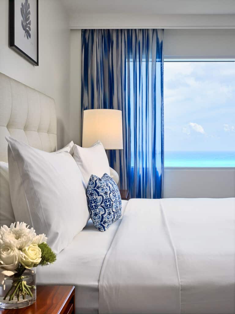 Hotel guestroom bed, and an ocean view.