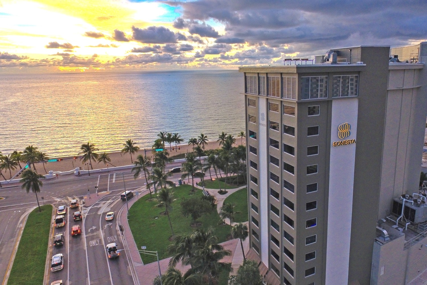 Aerial view of hotel near the beach and cityscape.