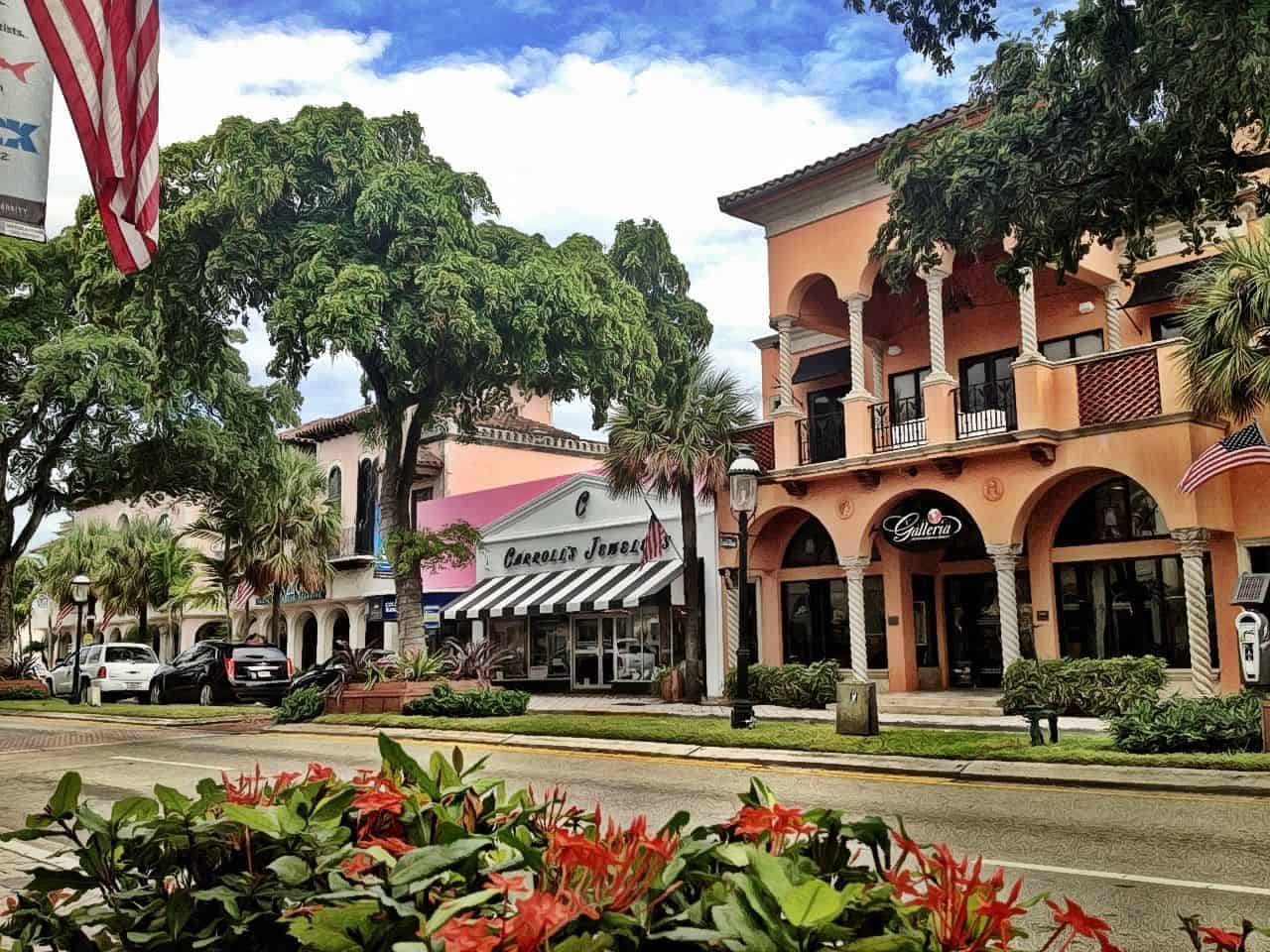 Charming street view with shops, trees, and flowers.